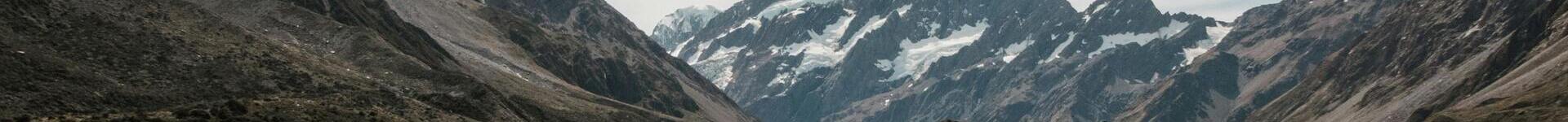 A horizontal banner image depicting a snowy mountain.